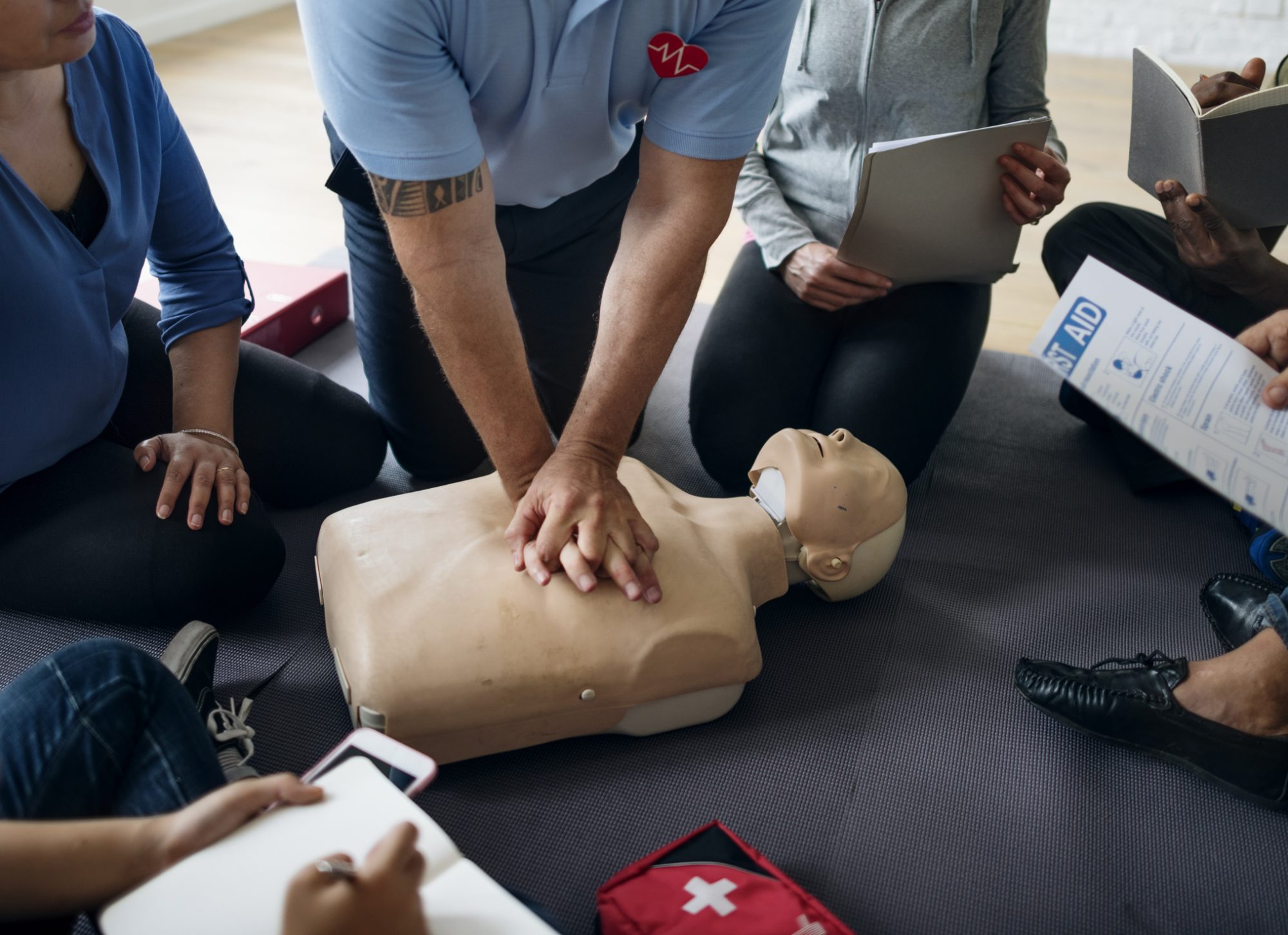 First aid training session with instructor demonstration